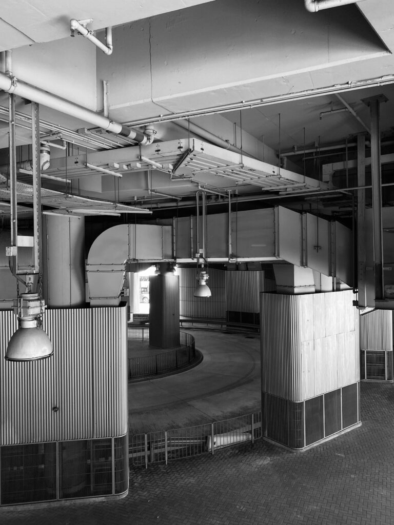 Explore the intricate design of an industrial underground space, featuring pipes and lamps.