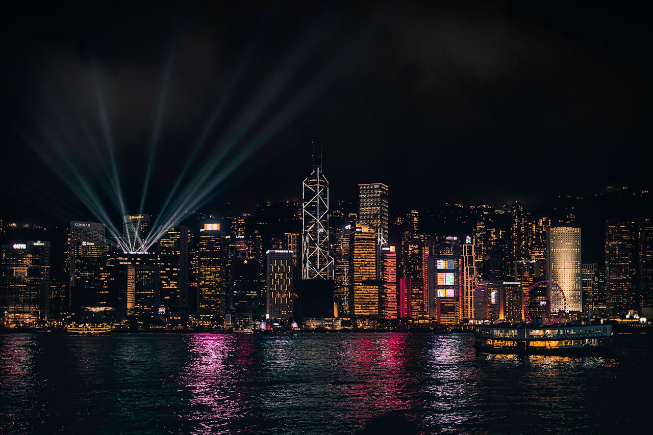 Stunning night view of Hong Kong skyline with vibrant lights reflecting on the water.